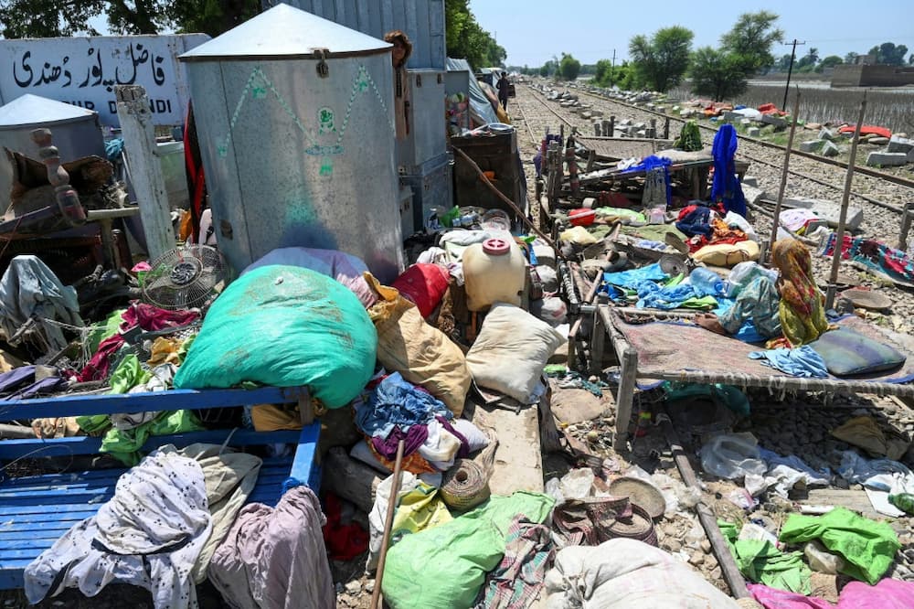Belongings of flood-affected people lie on a railway track -- the only strip of dry land -- in Fazilpur