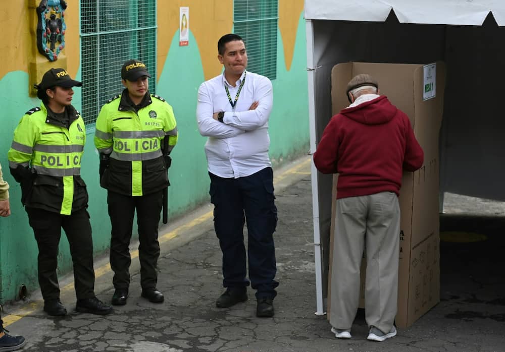 A man votes during the Colombian presidential runoff election, in Bogota on June 19, 2022, with voters filled with uncertainty over deciding between ex-guerrilla Gustavo Petro and millionaire businessman Rodolfo Hernandez