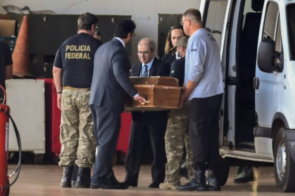 One of the coffins containing human remains found during the search for British journalist Dom Phillips and indigenous expert Bruno Pereira in the Amazon is carried at a  police hangar in Brasilia, on June 23, 2022