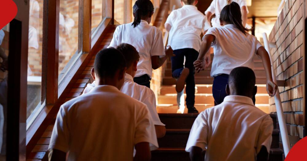 Students running up the stairs.