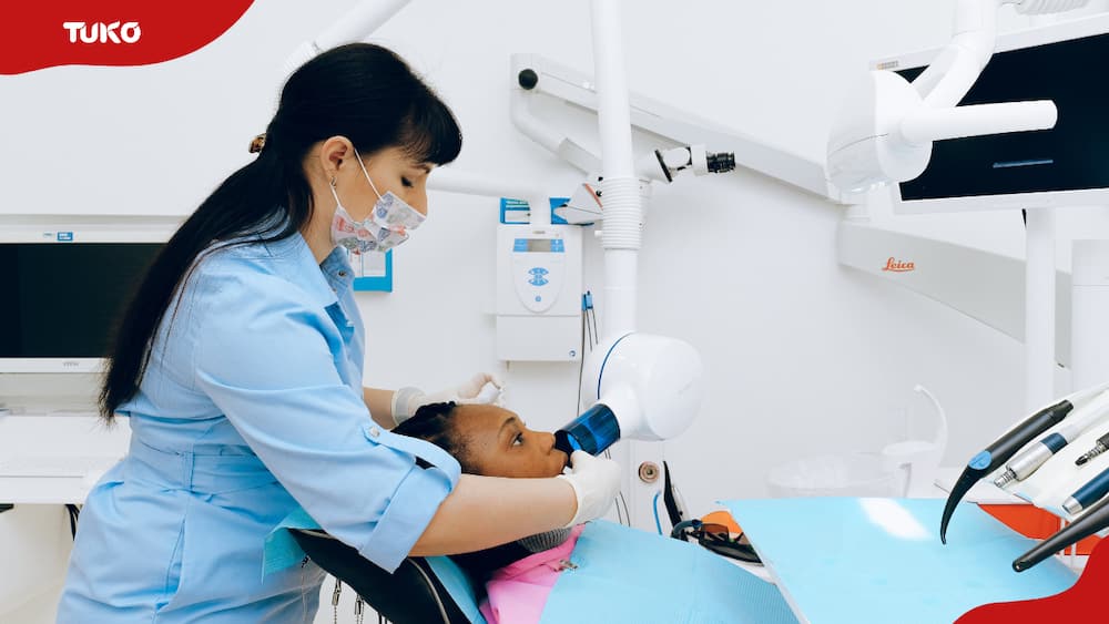 A dentist checking a patient's teeth