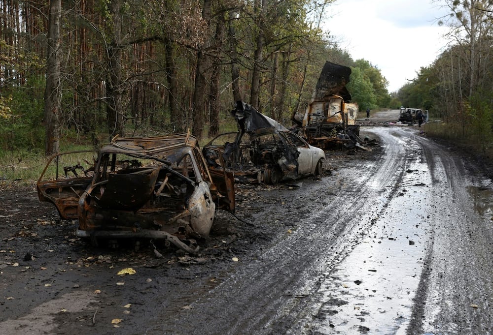 Destroyed civilian vehicles on a road near Izyum, Kharkiv region in eastern Ukraine  after the Russian troops left the key town of Lyman