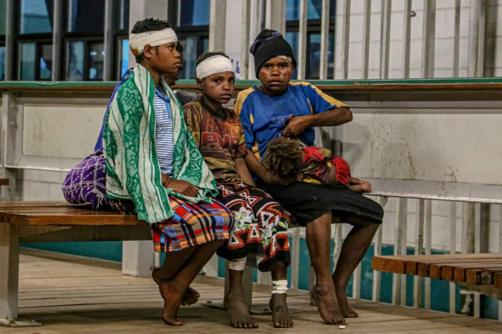 Injured villagers wait at a hospital after being evacuated by helicopter from Wauko Village following Sunday's 7.6-magnitude quake in Papua New Guinea