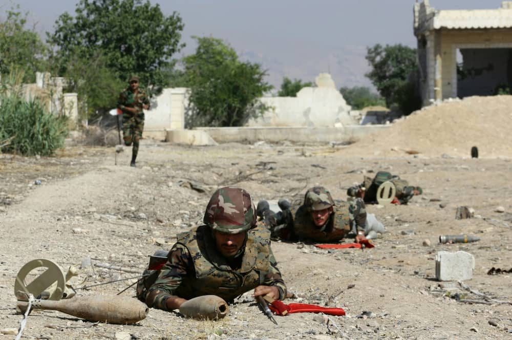 Syrian soldiers take part in a training session to remove and neutralise unexploded ordnance near the capital Damascus