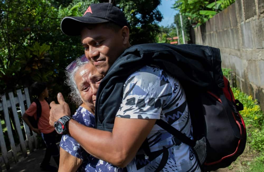 Moises Espinoza hugs his grandmother before leaving Nicaragua in a bid to reach the United States alongside his counsin Jose Galeano