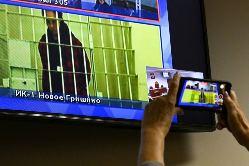 US basketball player Brittney Griner, who was sentenced to nine years in a Russian penal colony for drug smuggling, is seen on a screen via a video link during a court hearing at the Moscow regional court October 25, 2022