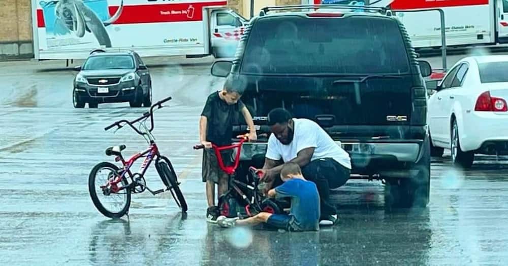 The man had just stepped out of his SUV when he noticed the boy trying to fix his bike.