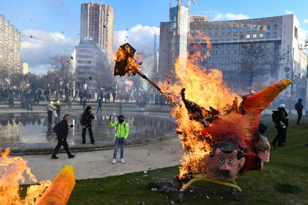Demonstrators burn an effigy of Macron during a pensions protest in Paris on April 6