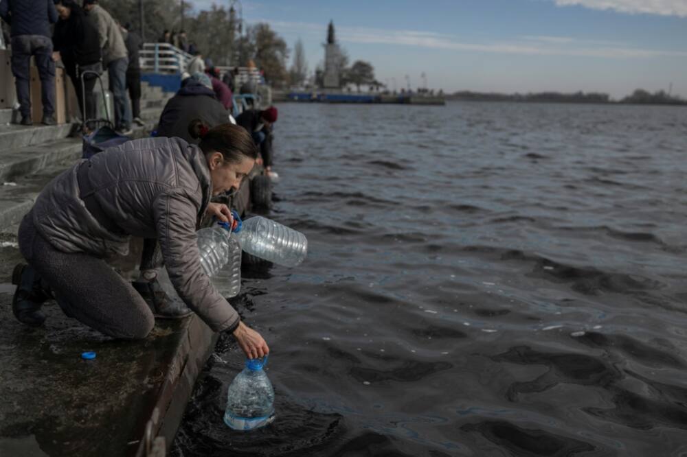 People were drawing river water in Ukraine's Kherson after supplies were knocked out