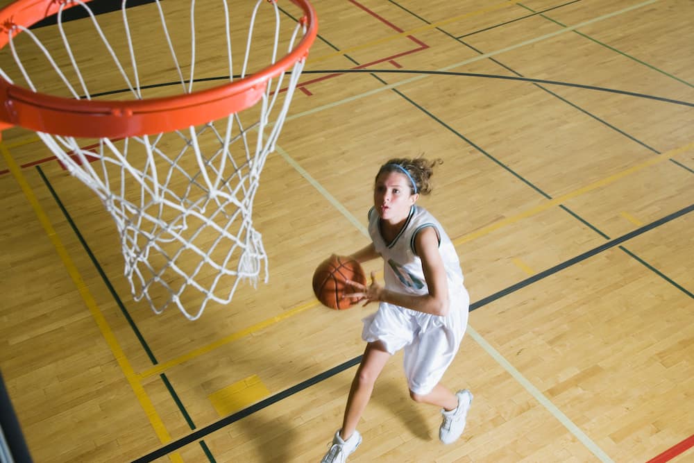 An elevated view of a teenage girl playing basketball