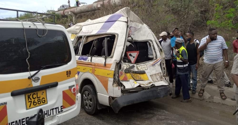 Residents mill around the area where a 14-seater matatu shot off a bridge and crashed into an oncoming lorry. Photo: Citizen.