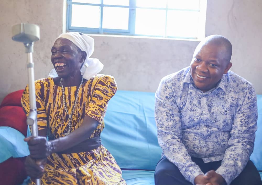 Siaya widow Ann Adhiambo (l) inside her new house with Victor Ayugi (r).