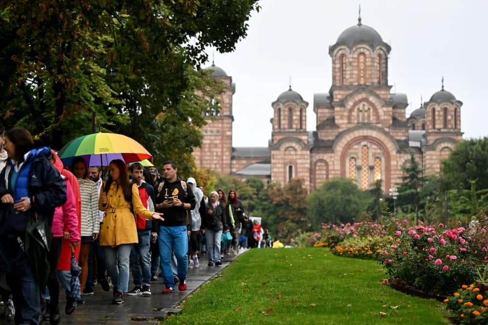 The Pride marchers walk past an Orthodox church in Belgrade