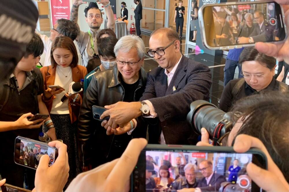 Nvidia chief Jensen Huang (centre L) poses for photographs before attending a press conference at Computex 2023 in Taipei on May 30, 2023.