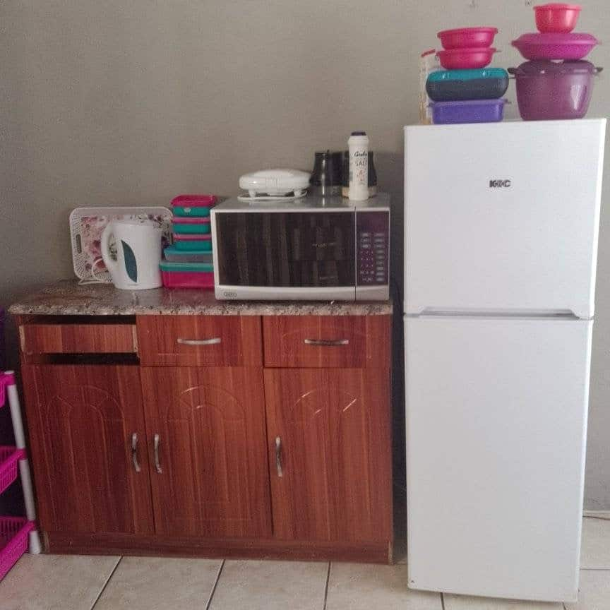 The lady shows her kitchen and how it looks.