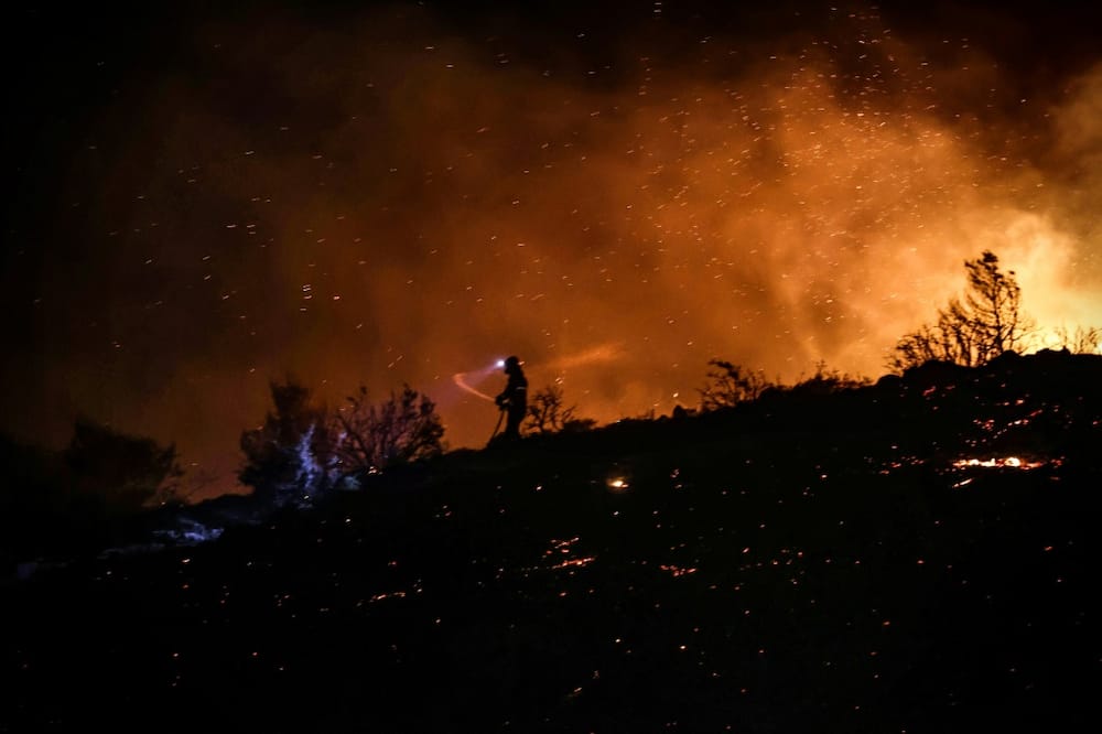 Wildfires on the foot of Mount Penteli north of Athens were fanned by gale-force winds