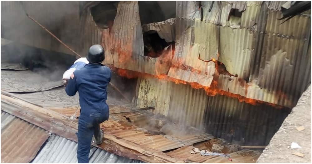 A man tries to put out a fire that razed several houses in the Mukuru-Kayaba slum.