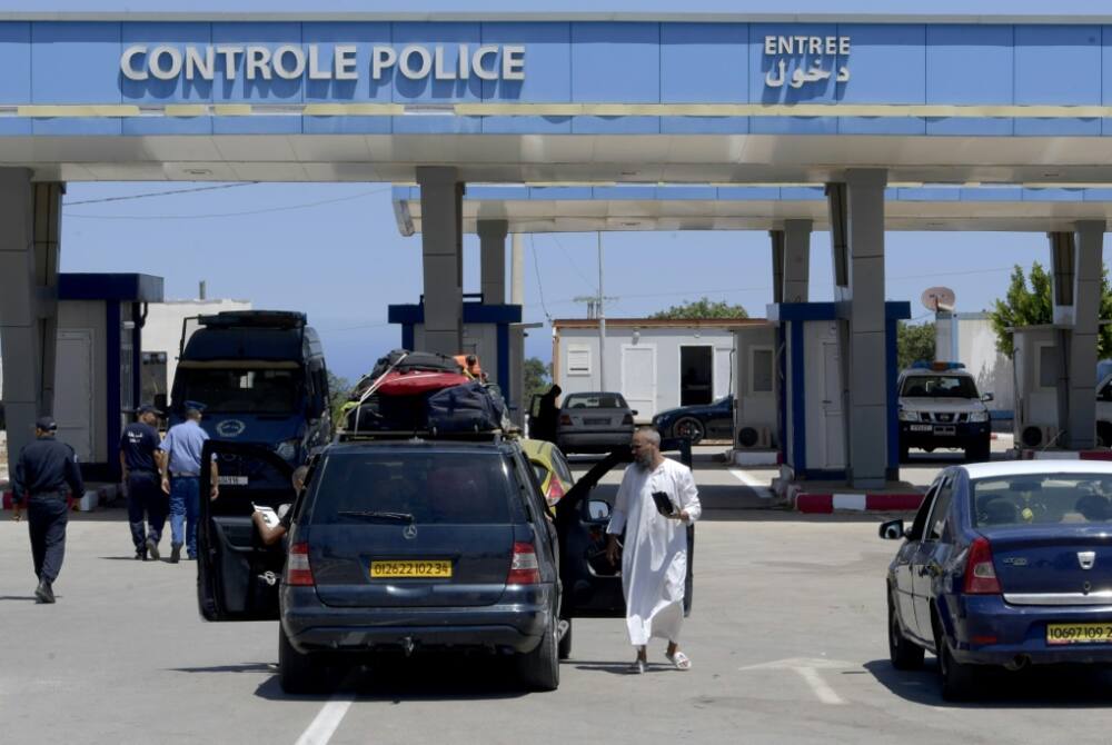 Travellers gather at Tunisia's Tabarka border post with Algeria after it reopened on July 15, two years on from its closure due to the Covid-19 pandemic