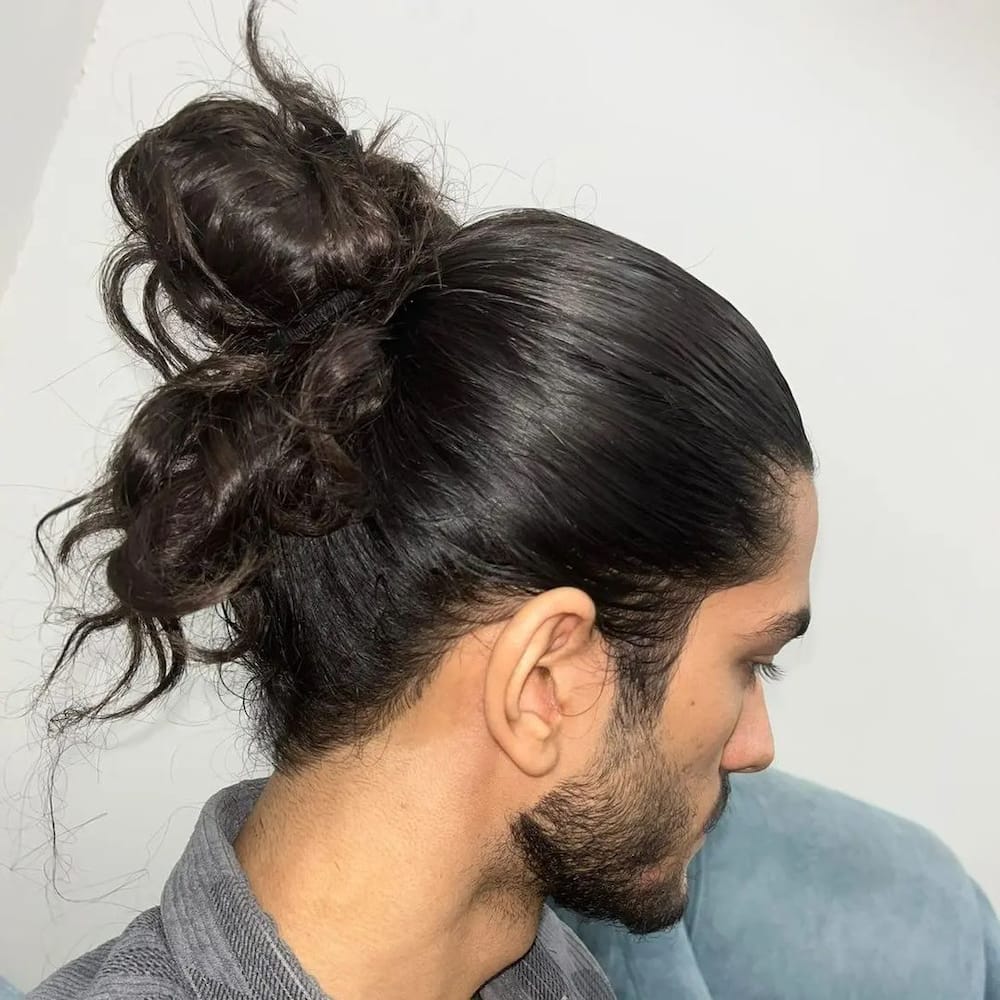 Man bun hairstyle for long face shapes.