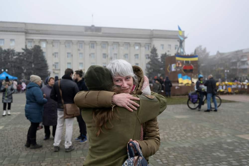 A woman hugs her friend in recently liberated Kherson