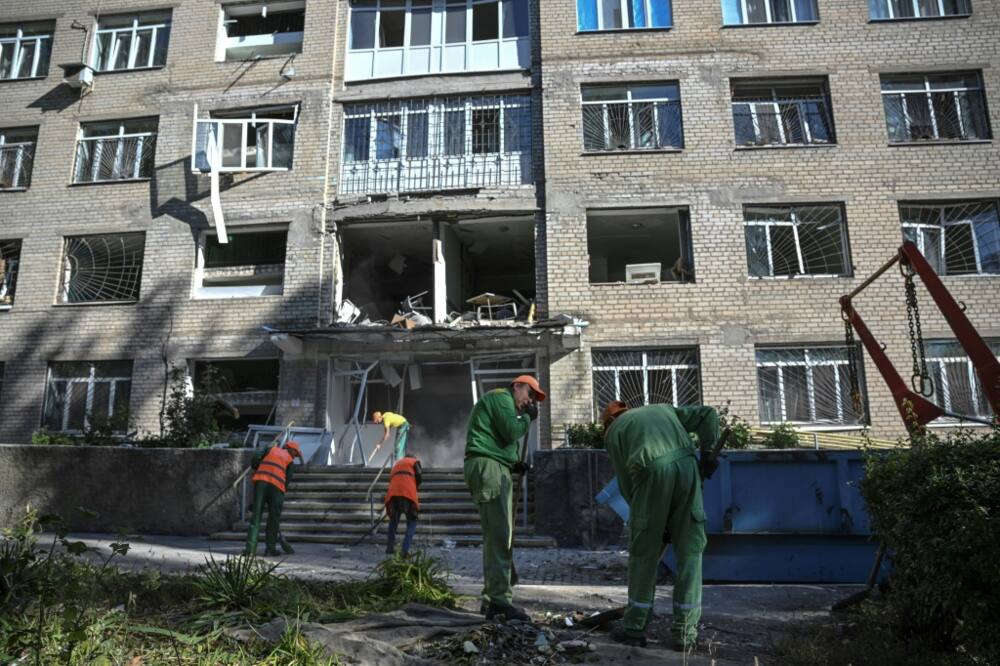 Workers collect debris from a psychiatric hospital after it was destroyed by a missile in Kramatorsk, Donetsk region, on September 7, 2022, amid the Russian invasion of Ukraine.