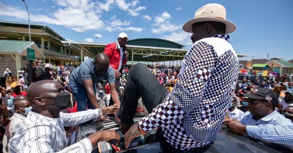 Two hawkers gave Raila a pair of shoes during his tour of Mt Kenya.