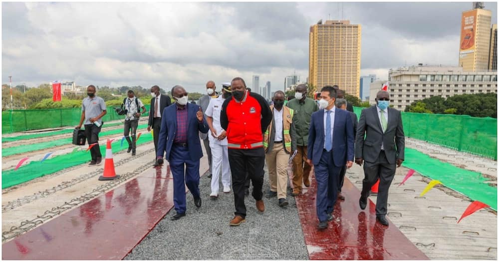 President Uhuru Kenyatta, Transport CS James Macharia and Moja Expressway officials inspecting the Nairobi Expressway construction in 2021.
