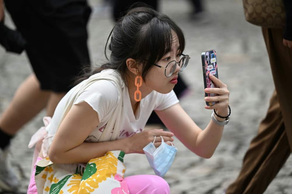A Chinese tourist takes a photo in Macau during the country’s week-long holiday at the start of October