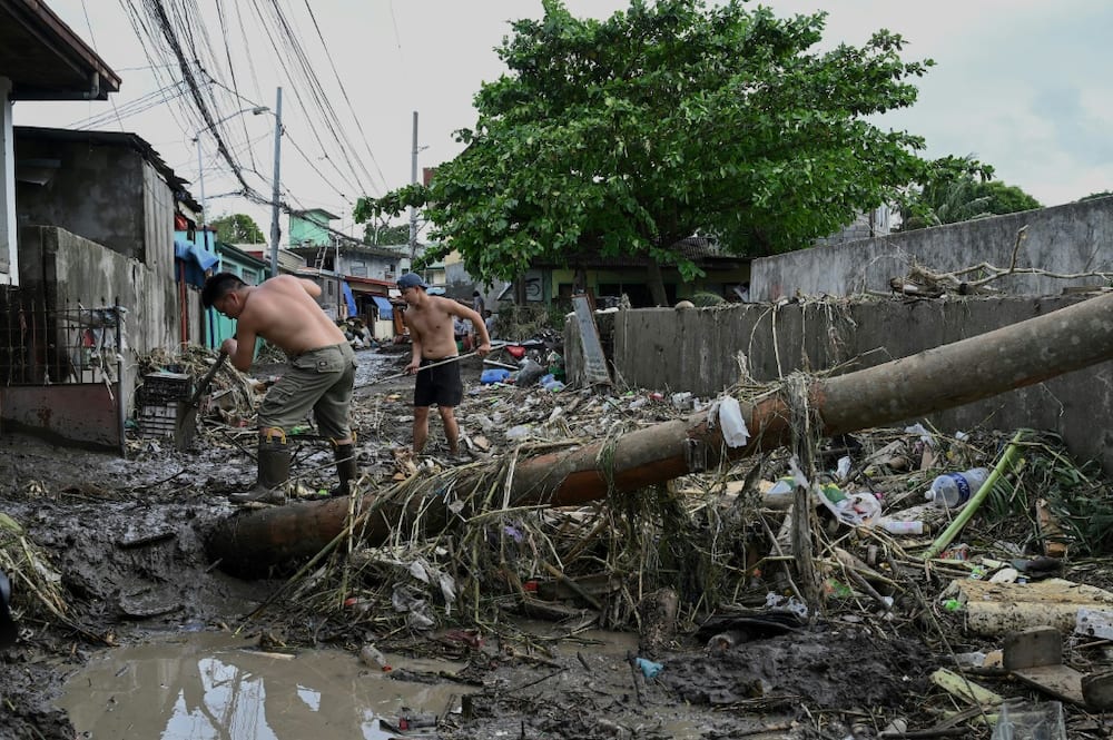 The death toll from floods and landslides unleashed by a tropical storm in the Philippiones jumps sharply to 98