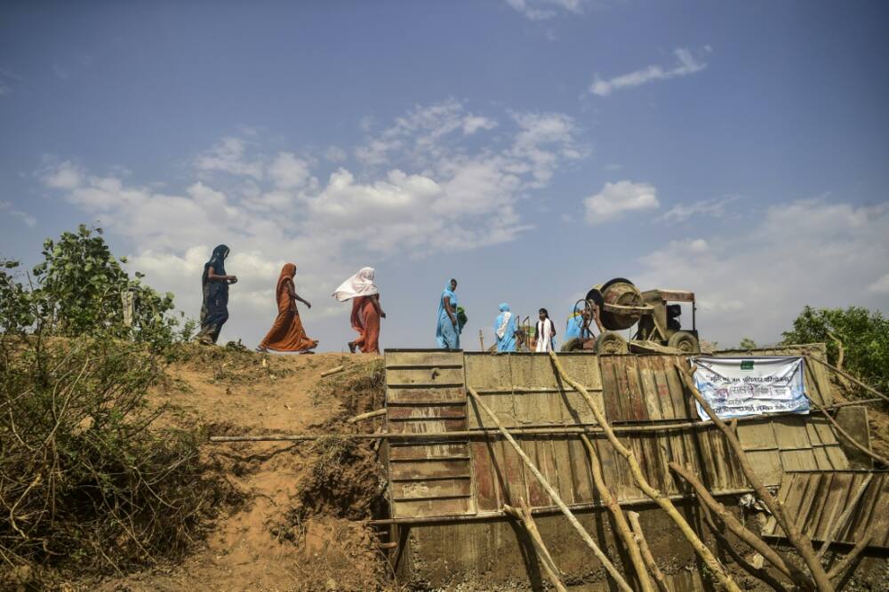 Volunteers from Jal Saheli ‘Friends of water’ help to build a check dam on dried up Bachedi stream in Agrotha