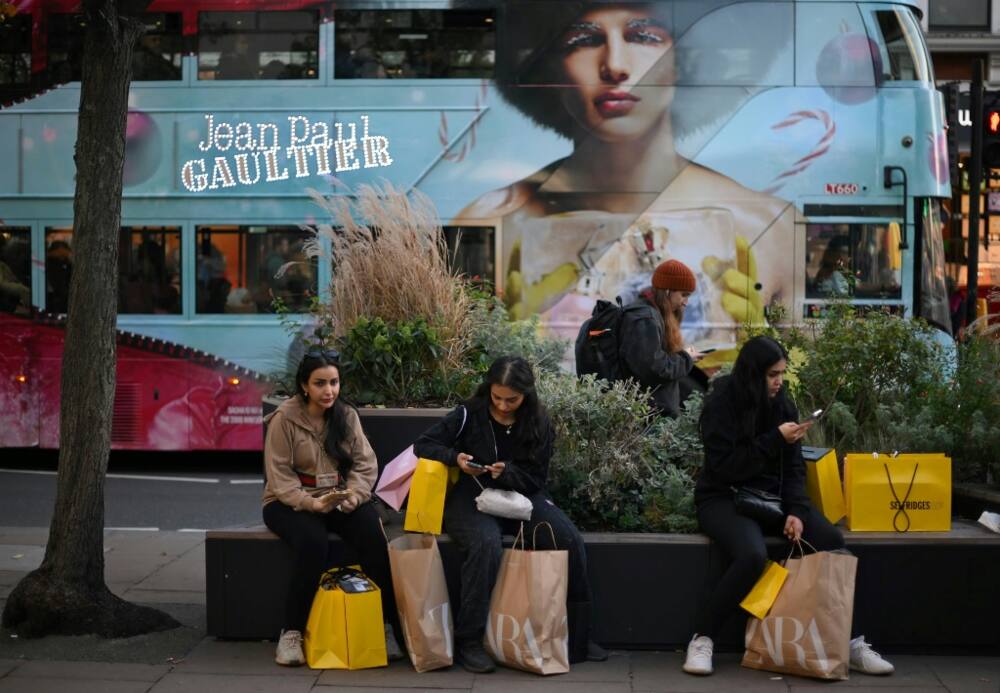Shoppers with Zara-branded bags in London last month