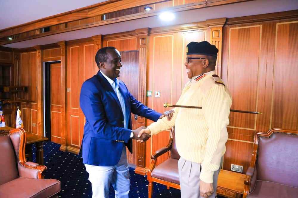 Reuben Lotiatia (R) shaking hands with Governor Patrick Ole Ntutu (L)