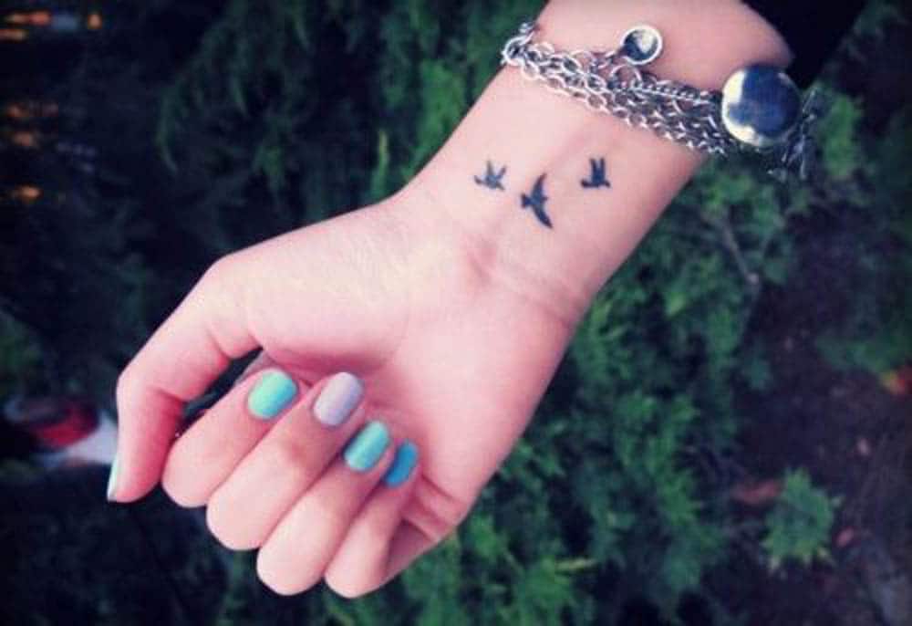 Minimalistic style anchor tattoo placed on the wrist.
