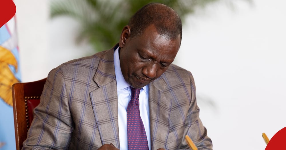 President William Ruto signs a document at his office.