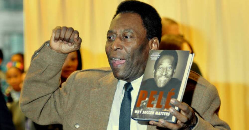 Brazilian soccer star Pele poses with his book, "Why Soccer Matters"