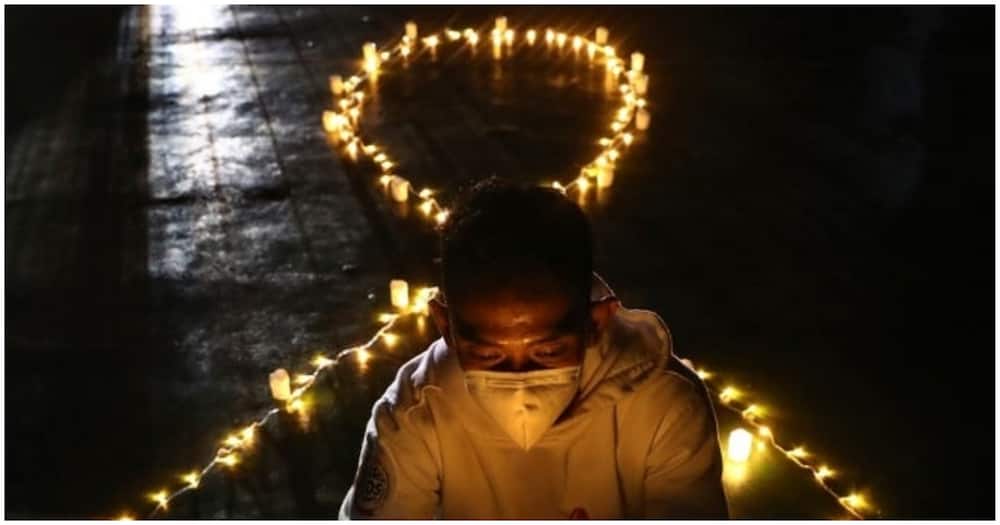 An Indonesian activist holds an electric candle during a vigil commemorating World AIDS day.