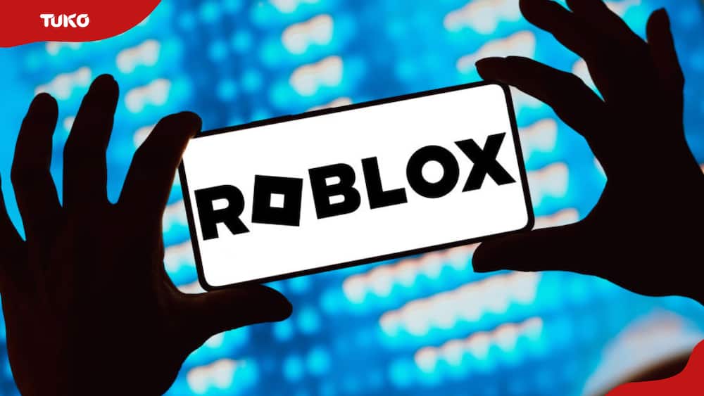 The Roblox logo is displayed on a smartphone screen