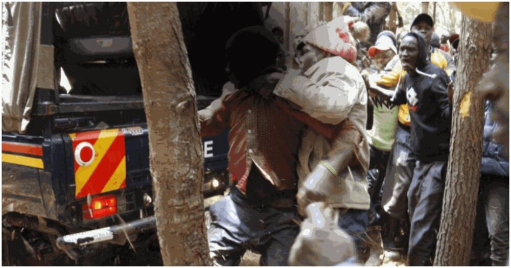 A man who allegedly killed his wife in Nakuru being frogmarched into a police vehicle. Photo: Nation.