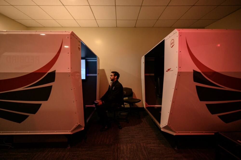 An instructor watches as a student pilot undergoes a training session in a flight simulator at the Farmingdale State College in Farmingdale, New York