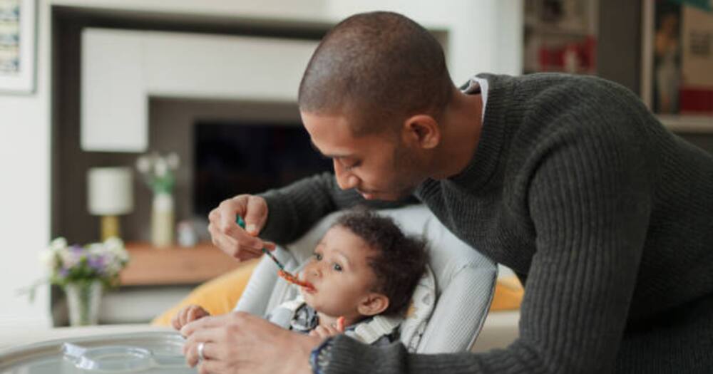 Feeding a baby with a spoon.