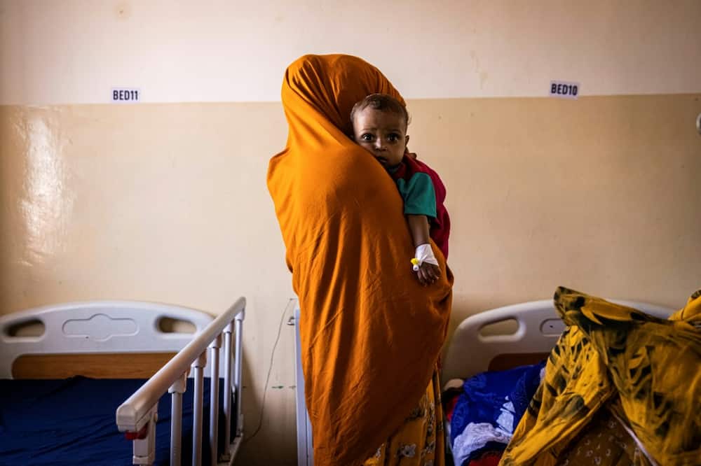 Hunger: A mother and her malnourished baby at the Banadir Maternity and Children Hospital in Mogadishu, the Somalian capital