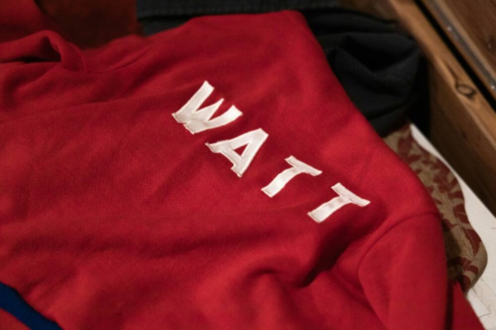 Jessica Watt lays out a sweater belonging to her late father Randy Watt, at her home in Bellaire, Ohio