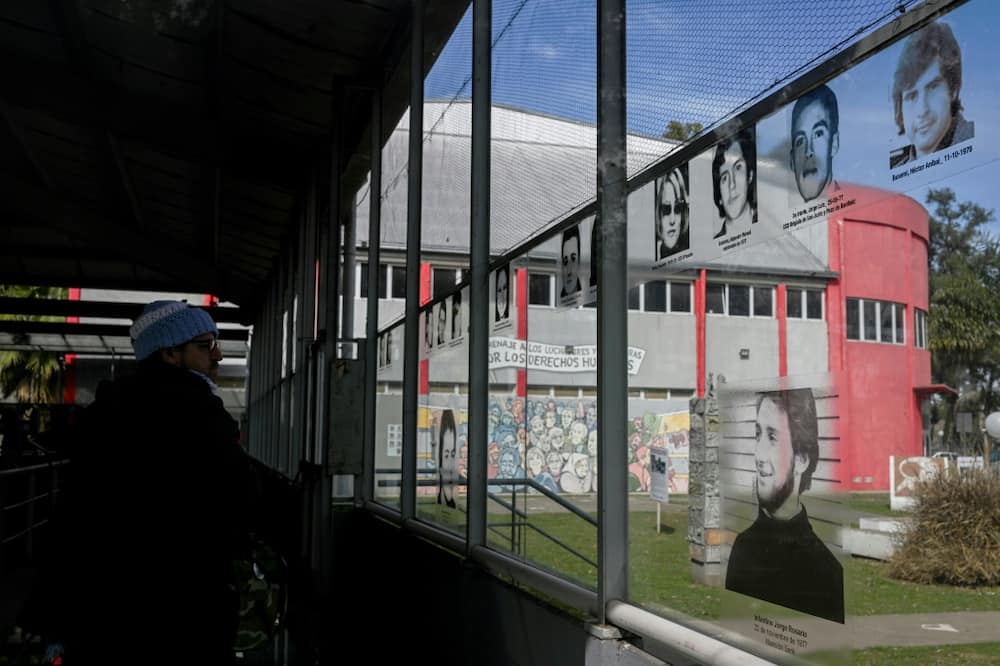 A man looks at pictures of victims of the Argentine dictatorship at a museum in a former clandestine detention center in Moron, Argentina, on Septembre 20, 2022