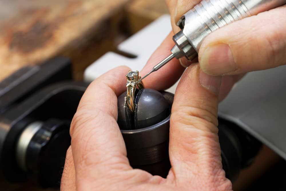 A jeweller repairs a diamond ring