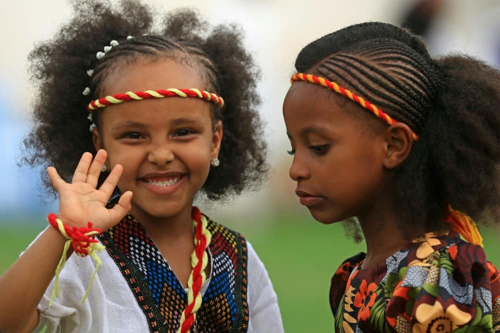 Ethiopian girls, wearing headbands in the colours of the Tigrayan flag, take part in the Ashenda celebrations at al-Qurashi park in the Sudanese capital Khartoum