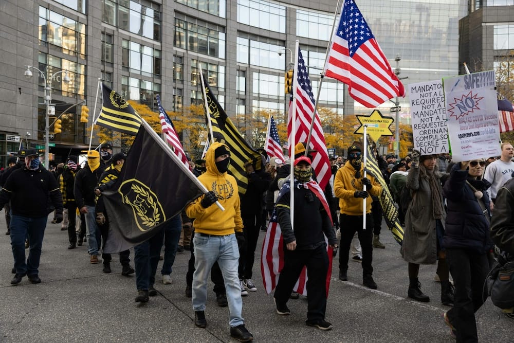In this file photo taken on November 20, 2021 members of Proud Boys march with demonstrators during an anti-mandate protest against the Covid-19 vaccine as part of a 'Global Freedom Movement' in New York