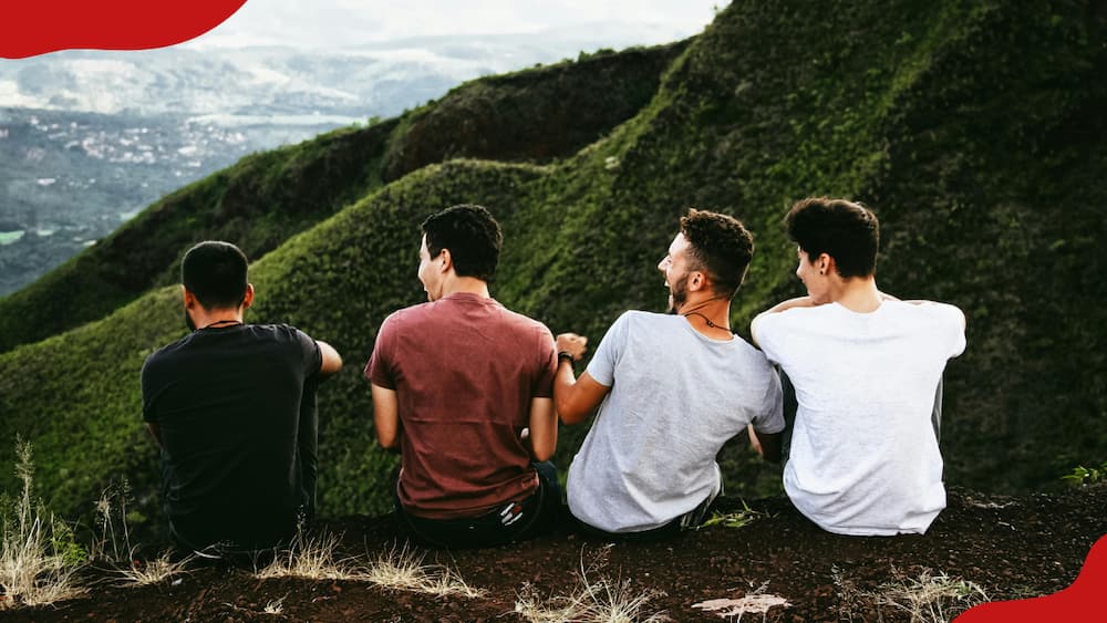 Four friends are sitting on the ground