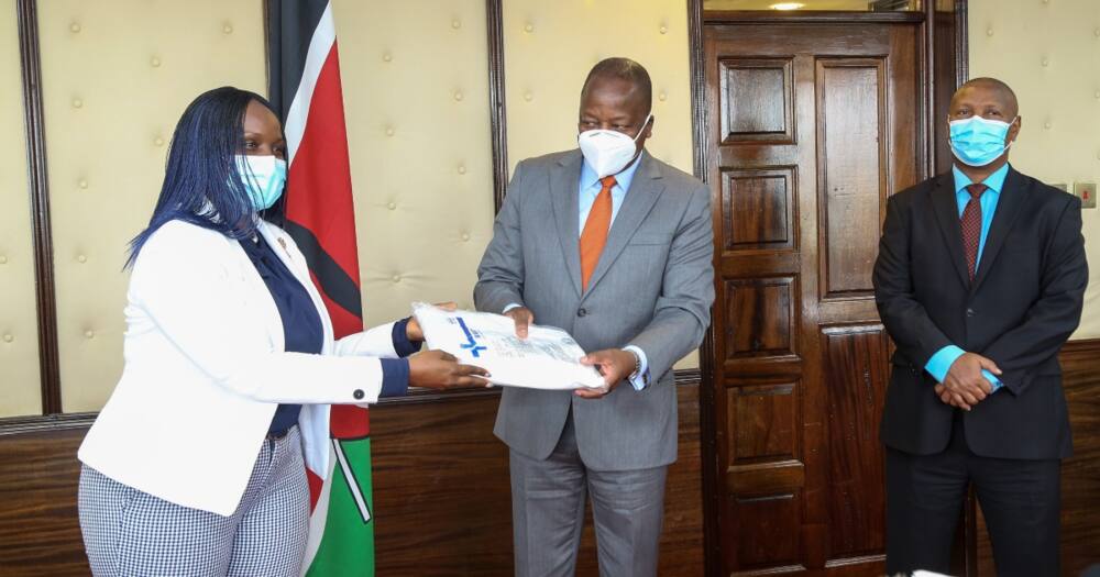 MultiChoice Kenya Managing Director Nancy Matimu handing over the company's PPEs donation to Health CS Mutahi Kagwe. Photo: MultiChoice Kenya.