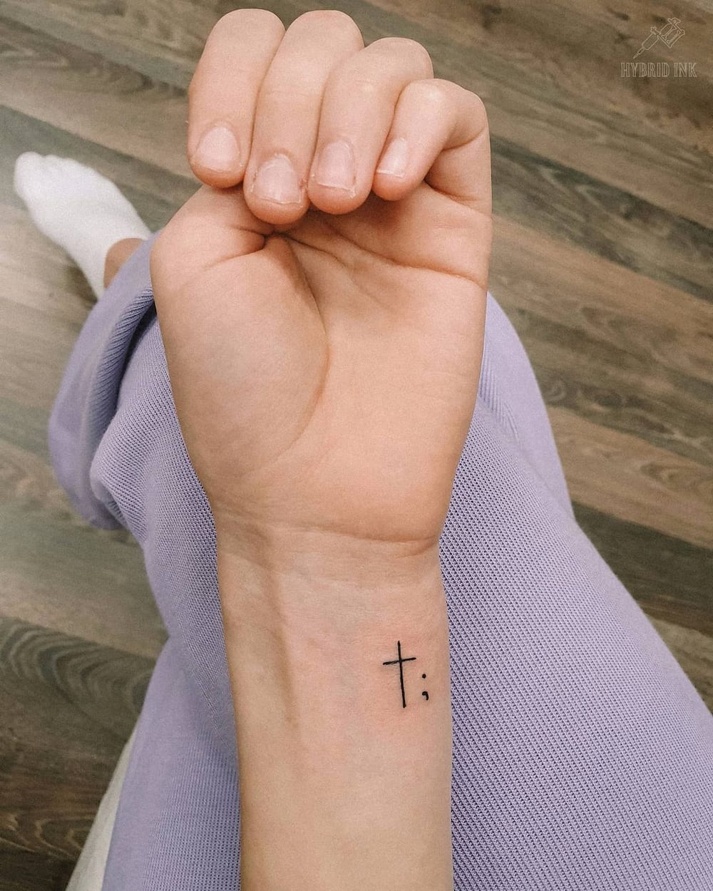 simple cross wrist tattoo