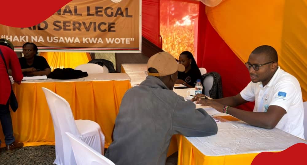 A Kenyan receives legal assistance at a mobile legal aid clinic